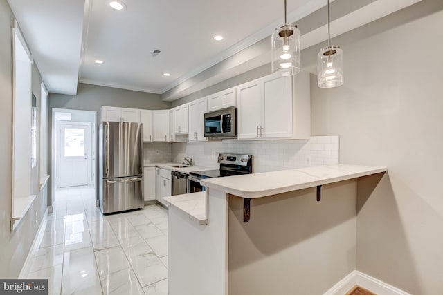 kitchen featuring a peninsula, a sink, white cabinetry, appliances with stainless steel finishes, and light stone counters