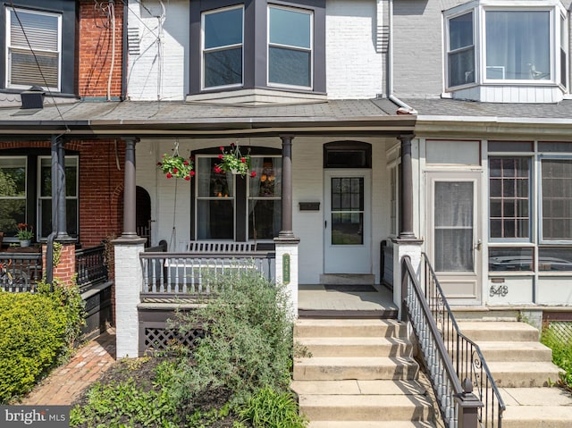view of front of property featuring covered porch and brick siding