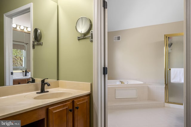 full bath with visible vents, a shower stall, a bath, and vanity