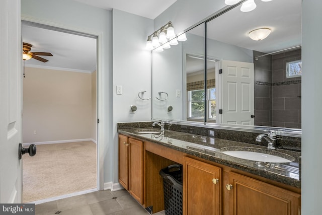 bathroom with double vanity, a sink, baseboards, and ceiling fan