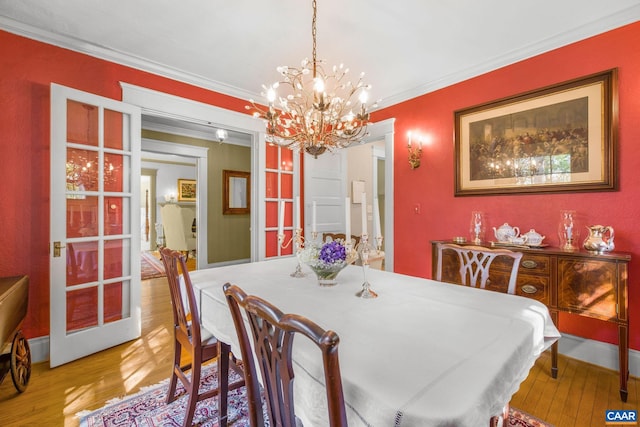 2616 Jefferson Park Cir, Charlottesville, VA 22903 - dining room with wood finished floors, an inviting chandelier, and crown molding