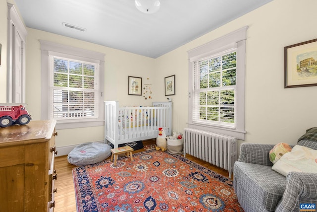 2616 Jefferson Park Cir, Charlottesville, VA 22903 - bedroom with radiator heating unit, light wood-style flooring, and multiple windows