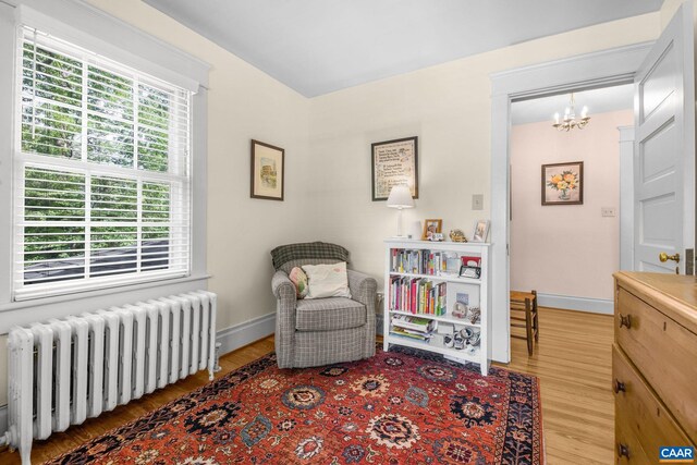 2616 Jefferson Park Cir, Charlottesville, VA 22903 - sitting room featuring baseboards, wood finished floors, an inviting chandelier, and radiator