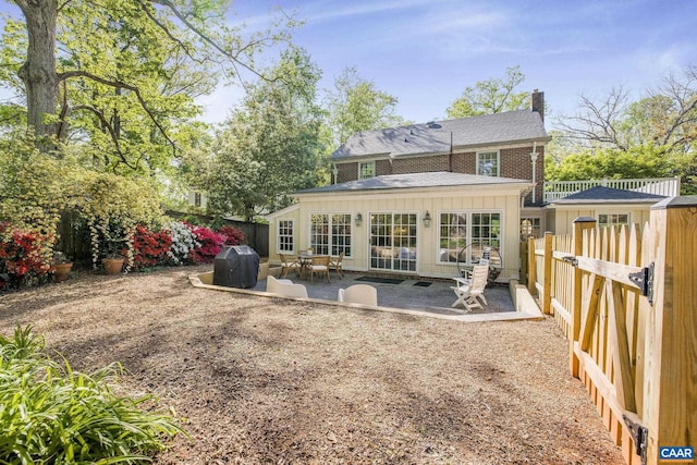 2616 Jefferson Park Cir, Charlottesville, VA 22903 - rear view of property with a fenced backyard, a chimney, a patio, and board and batten siding