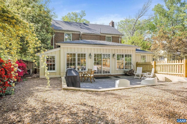 2616 Jefferson Park Cir, Charlottesville, VA 22903 - rear view of property with a patio area, a chimney, board and batten siding, a shingled roof, and fence