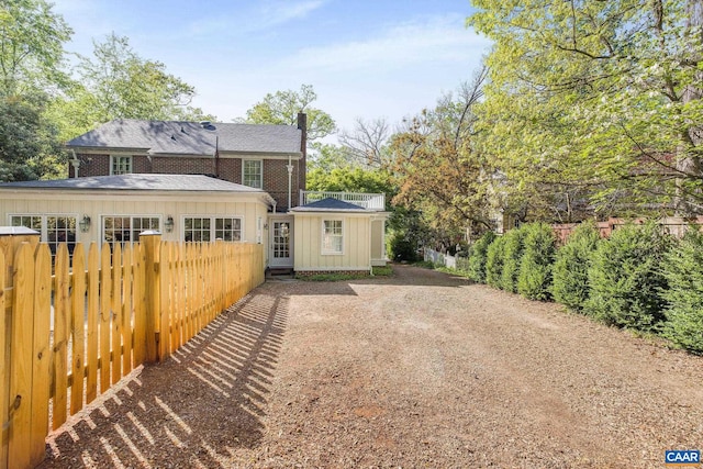 2616 Jefferson Park Cir, Charlottesville, VA 22903 - exterior space with a chimney, fence, roof with shingles, and board and batten siding