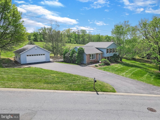 view of front of property with an outdoor structure, fence, a front lawn, and a garage