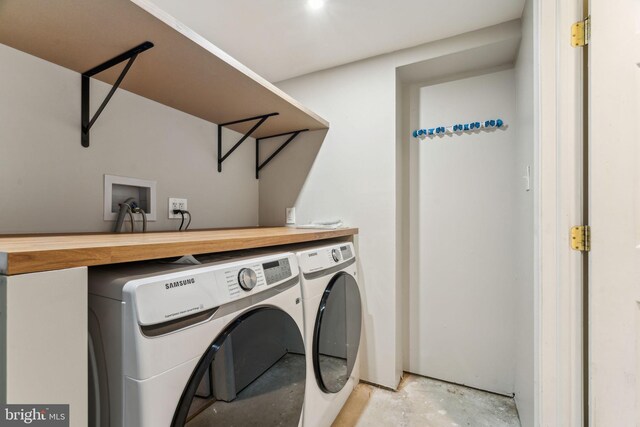 washroom featuring washing machine and clothes dryer and laundry area