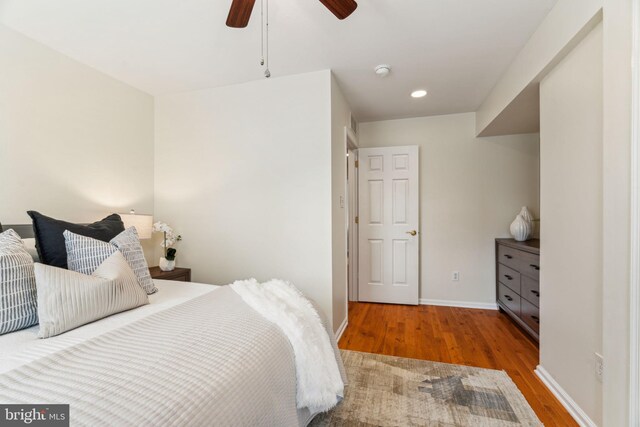 bedroom featuring baseboards, a ceiling fan, wood finished floors, and recessed lighting