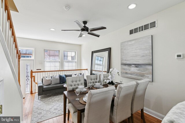 dining area featuring hardwood / wood-style floors, visible vents, and a wealth of natural light