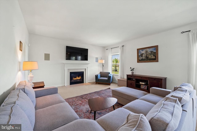 carpeted living room featuring a glass covered fireplace