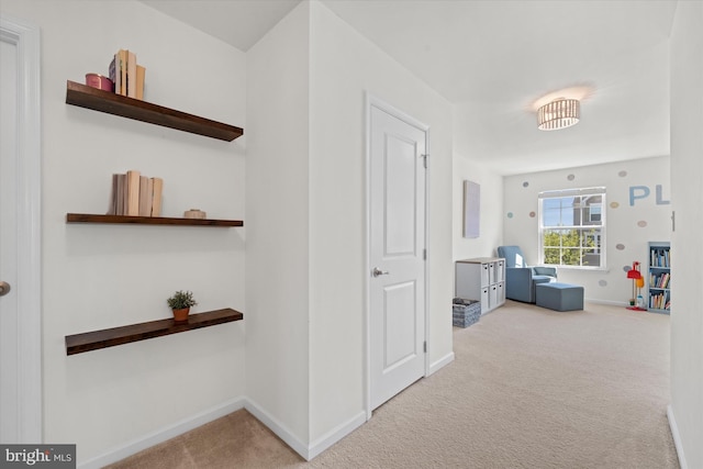 corridor featuring carpet floors and baseboards