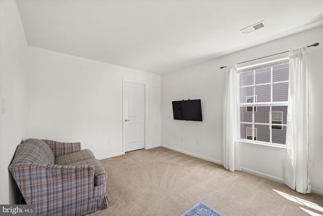 sitting room featuring baseboards, visible vents, and carpet floors