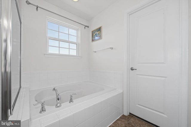 full bathroom with a bath and tile patterned flooring