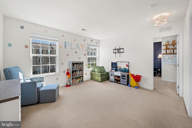 playroom with baseboards, a healthy amount of sunlight, carpet flooring, and visible vents
