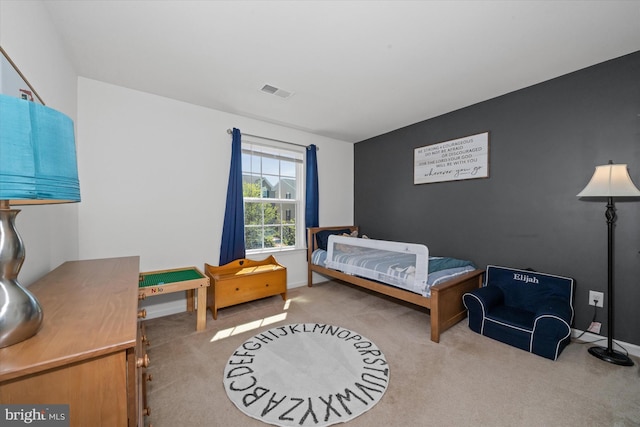 bedroom featuring baseboards, visible vents, and carpet