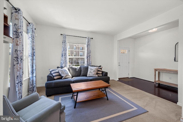 carpeted living room with baseboards