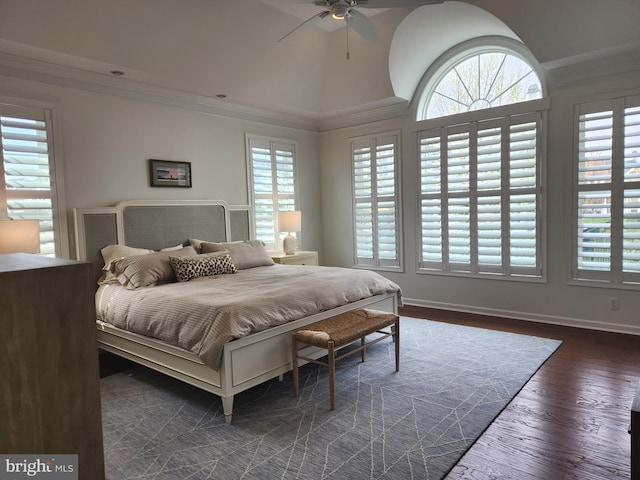 bedroom featuring dark wood finished floors, vaulted ceiling, baseboards, a ceiling fan, and crown molding