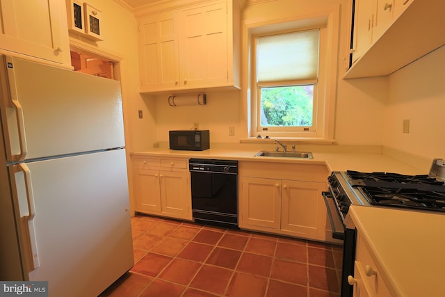 2203 N Grant Ave, Wilmington, DE 19806 - kitchen with a sink, light countertops, tile patterned floors, black appliances, and white cabinetry