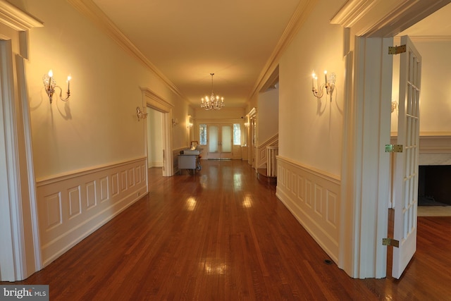 2203 N Grant Ave, Wilmington, DE 19806 - hallway featuring a wainscoted wall, ornamental molding, dark wood-style floors, and a chandelier