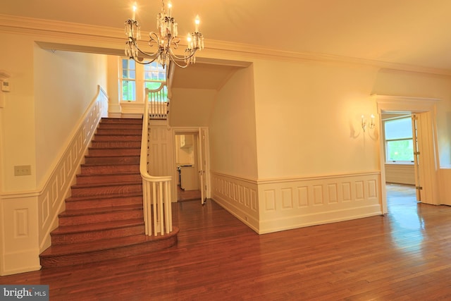 2203 N Grant Ave, Wilmington, DE 19806 - stairway featuring a wainscoted wall, wood finished floors, and a chandelier