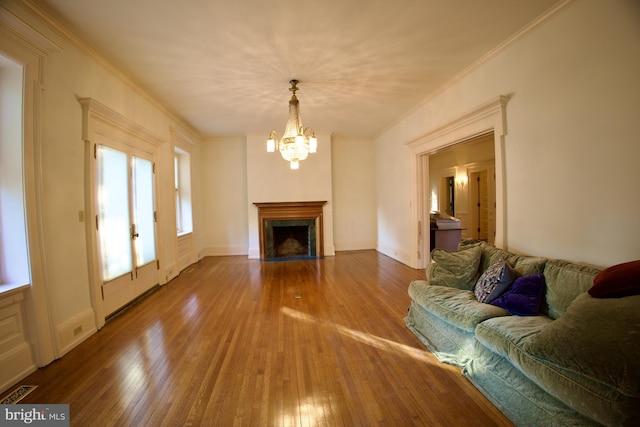 2203 N Grant Ave, Wilmington, DE 19806 - living room featuring visible vents, wood-type flooring, an inviting chandelier, ornamental molding, and a premium fireplace