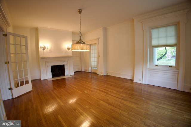 2203 N Grant Ave, Wilmington, DE 19806 - unfurnished living room featuring baseboards, ornamental molding, a fireplace, and hardwood / wood-style floors