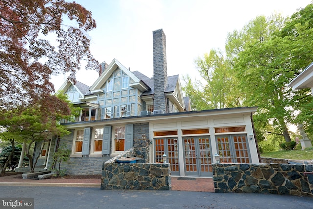 2203 N Grant Ave, Wilmington, DE 19806 - rear view of house featuring french doors, stone siding, and a chimney
