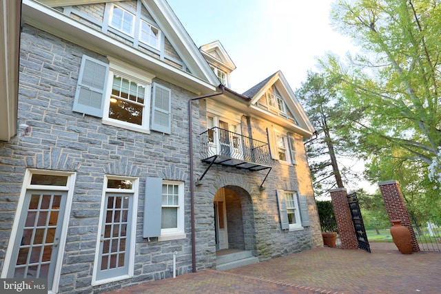 2203 N Grant Ave, Wilmington, DE 19806 - view of front facade with stone siding, a patio area, and a balcony