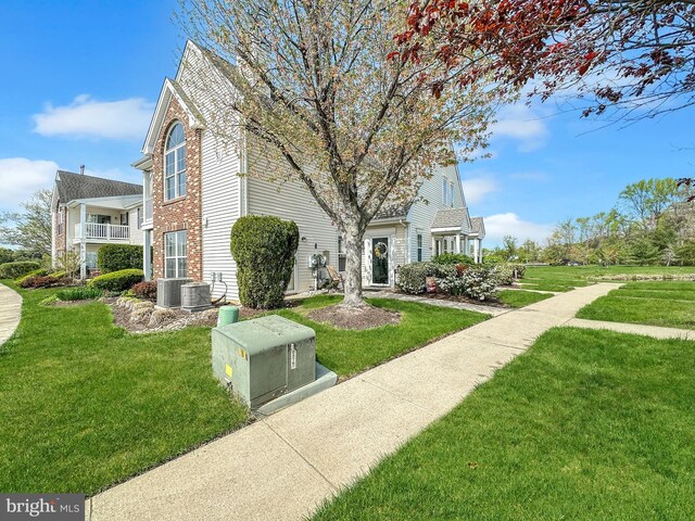 2002 Staghorn Dr, Mount Laurel, NJ 08054 - view of property exterior with brick siding, a yard, and central air condition unit