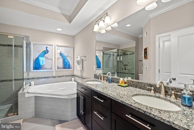bathroom featuring crown molding, a sink, a garden tub, and a stall shower