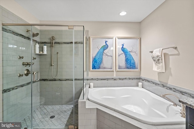 full bathroom featuring a shower stall, a garden tub, and recessed lighting