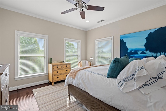 bedroom with crown molding, visible vents, wood finished floors, baseboards, and recessed lighting