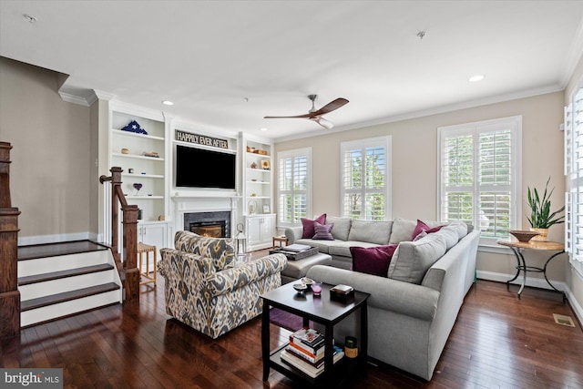 living room with baseboards, dark wood-style floors, ornamental molding, and ceiling fan