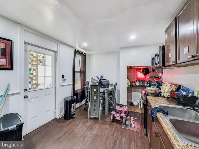 interior space featuring light countertops, stainless steel appliances, wood finished floors, and a sink