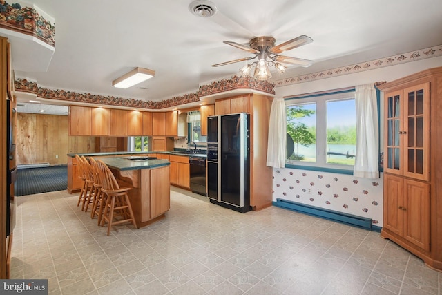 5537 Eldorado Sharptown Rd, Rhodesdale, MD 21659 - kitchen featuring black appliances, a baseboard radiator, dark countertops, ceiling fan, and a kitchen island