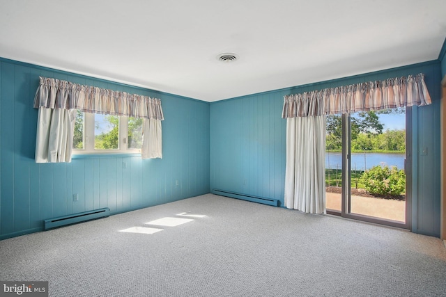5537 Eldorado Sharptown Rd, Rhodesdale, MD 21659 - carpeted empty room featuring baseboard heating, a baseboard radiator, plenty of natural light, and a water view