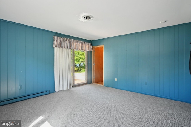 5537 Eldorado Sharptown Rd, Rhodesdale, MD 21659 - carpeted spare room featuring a baseboard radiator and wooden walls