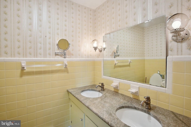 5537 Eldorado Sharptown Rd, Rhodesdale, MD 21659 - bathroom with tile walls, double vanity, a wainscoted wall, and wallpapered walls