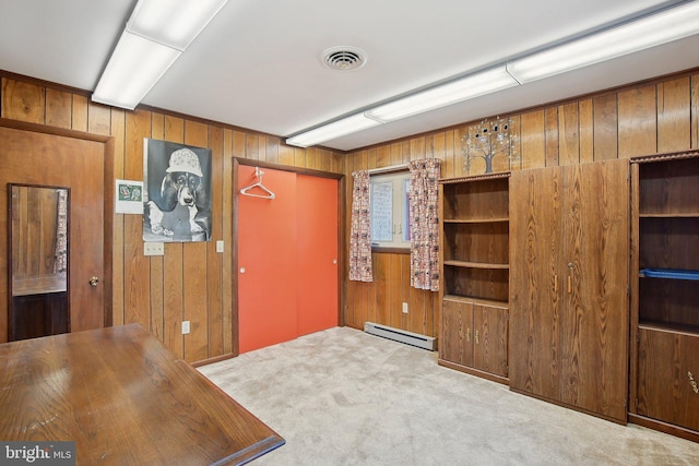 5537 Eldorado Sharptown Rd, Rhodesdale, MD 21659 - unfurnished dining area with a baseboard heating unit, wooden walls, and carpet flooring