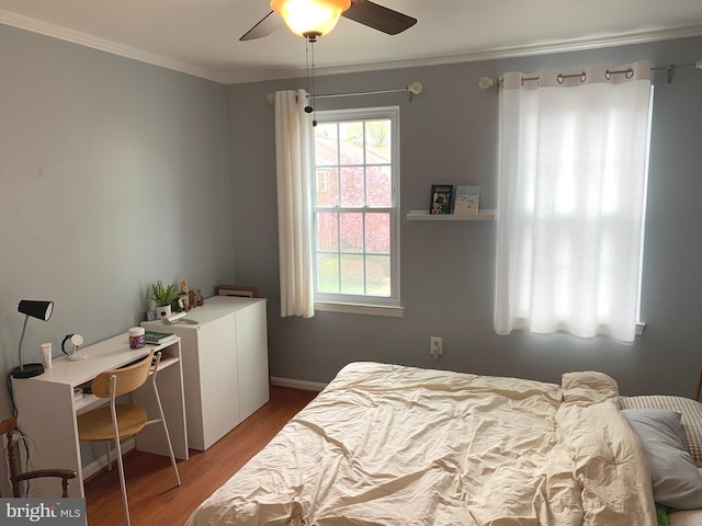 bedroom with wood finished floors, ceiling fan, and ornamental molding