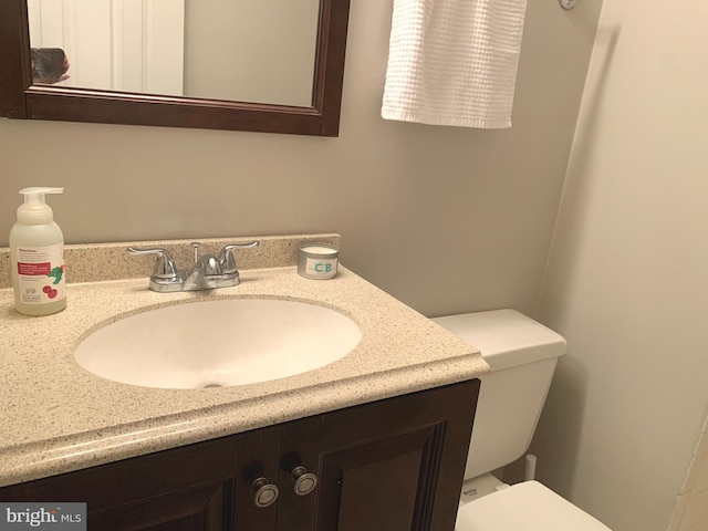 half bathroom with toilet and vanity