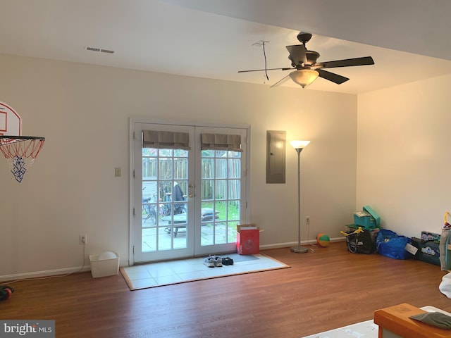 unfurnished living room featuring electric panel, visible vents, french doors, and wood finished floors