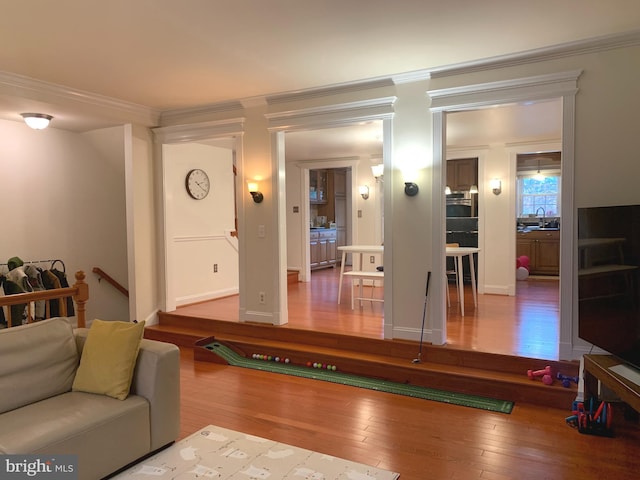 living room featuring wood-type flooring and ornamental molding