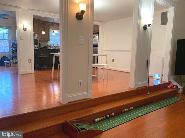 playroom with baseboards, visible vents, and wood finished floors