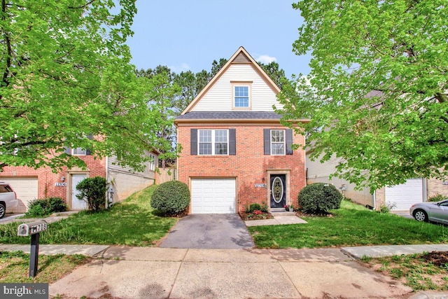 view of front facade featuring brick siding, an attached garage, a front lawn, and aphalt driveway