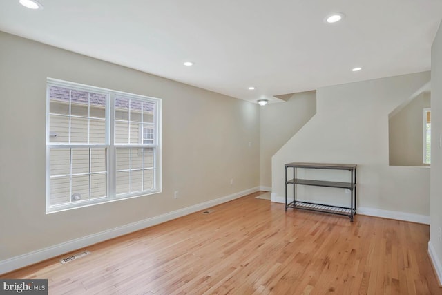 basement featuring baseboards, recessed lighting, and light wood-type flooring