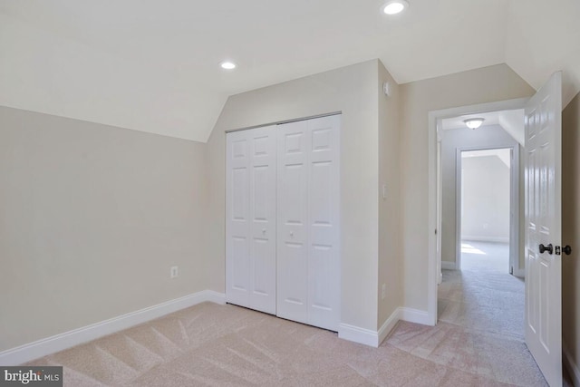 unfurnished bedroom featuring carpet floors, baseboards, vaulted ceiling, and recessed lighting
