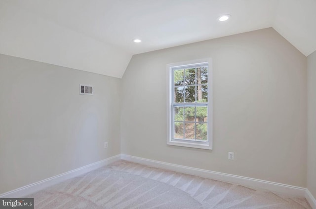 additional living space with baseboards, lofted ceiling, recessed lighting, and visible vents