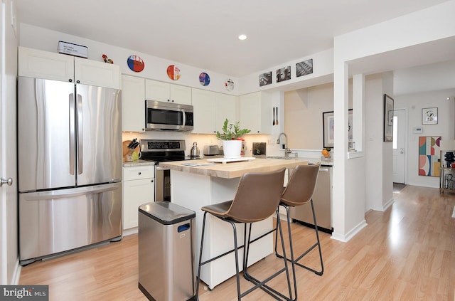 23 Academy Ct, Pennington, NJ 08534 - kitchen featuring a kitchen breakfast bar, stainless steel appliances, white cabinets, and a sink